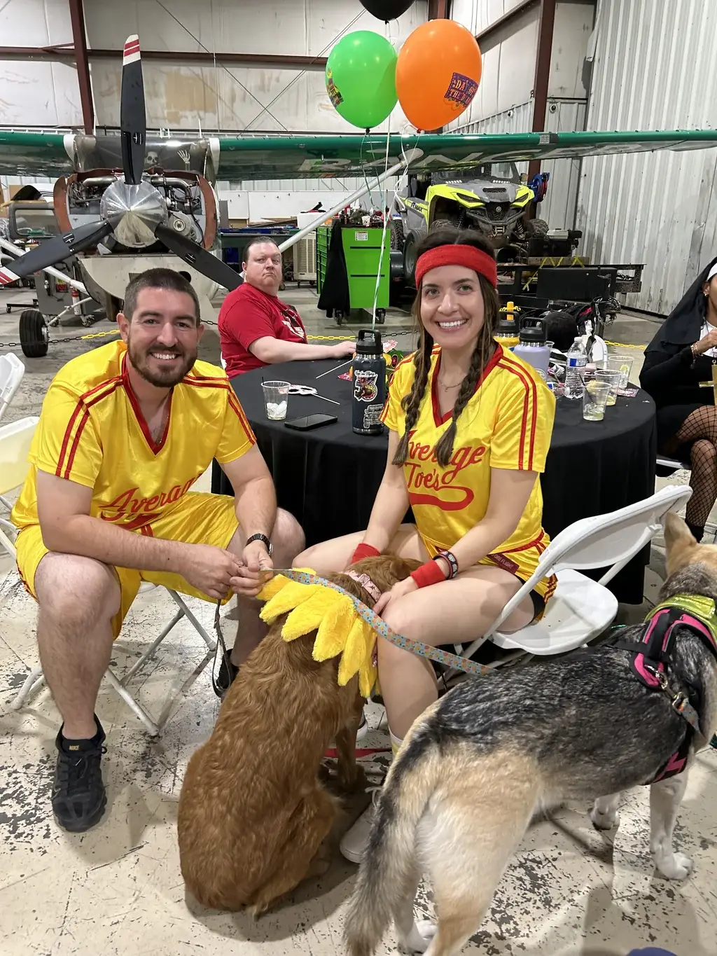 Guests in baseball costumes with dogs at Vegas Aviation