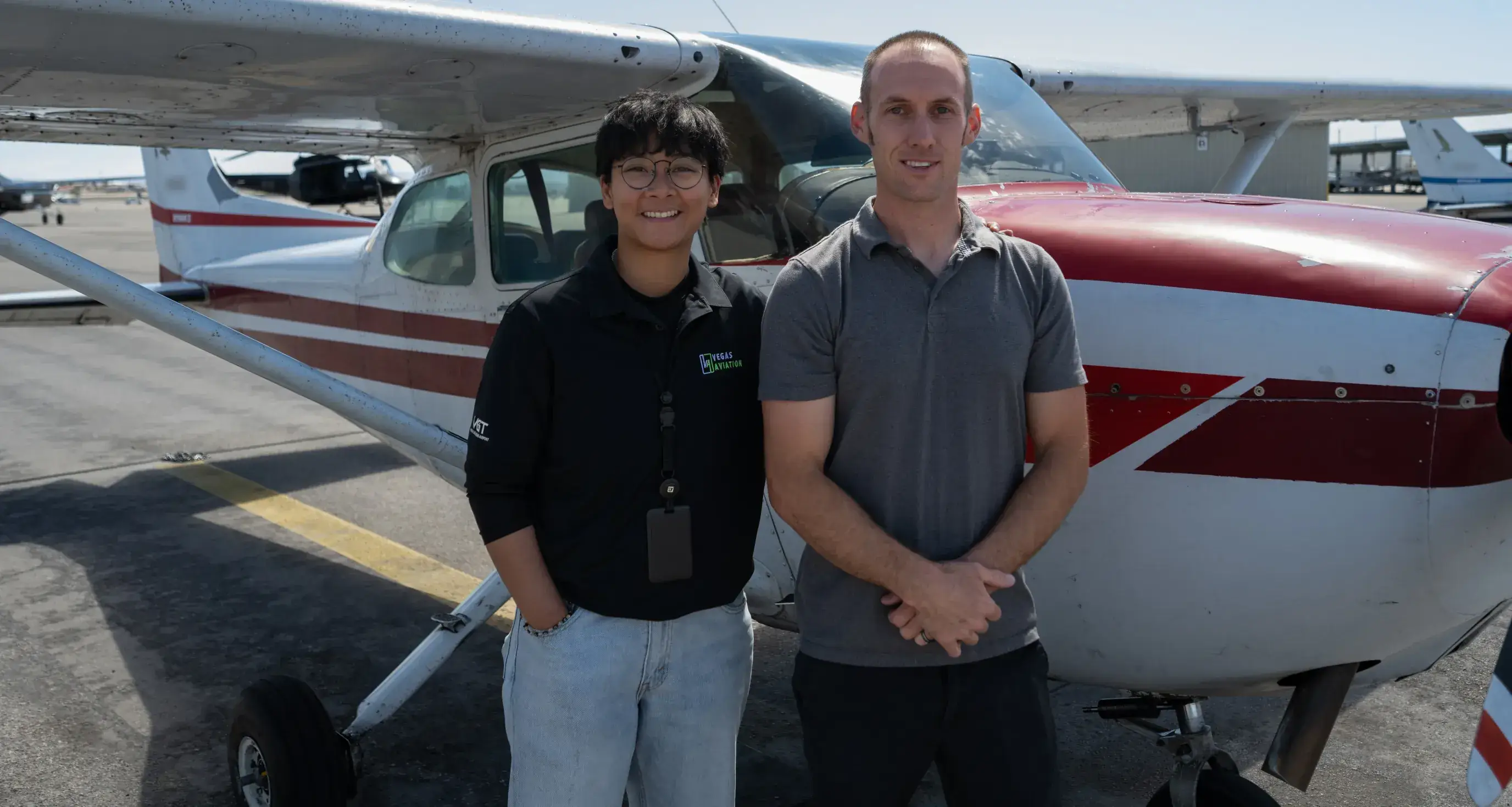 Flight instructor and student pilot in front of an aircraft