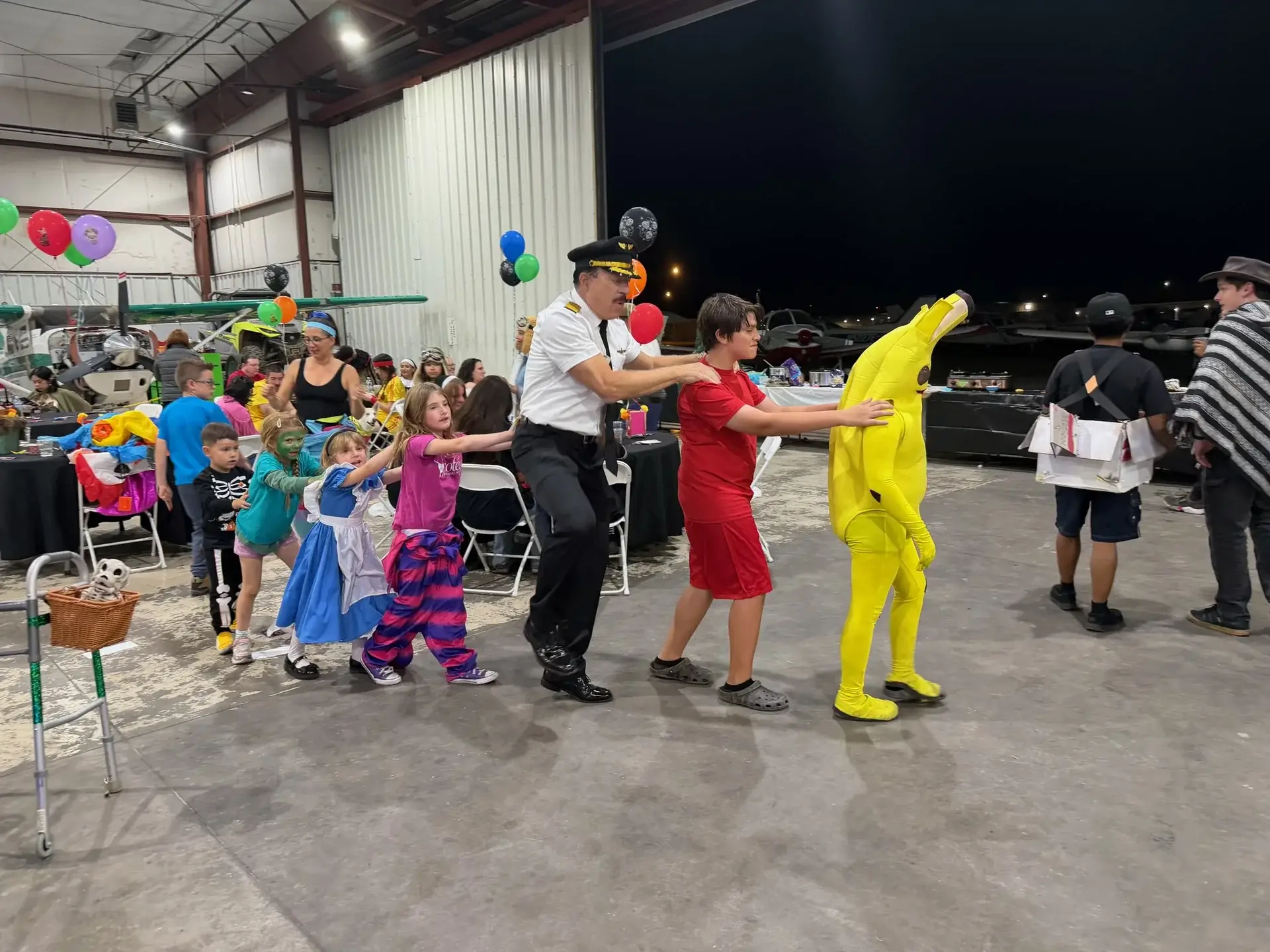 Costumed guests in a conga line at Vegas Aviation