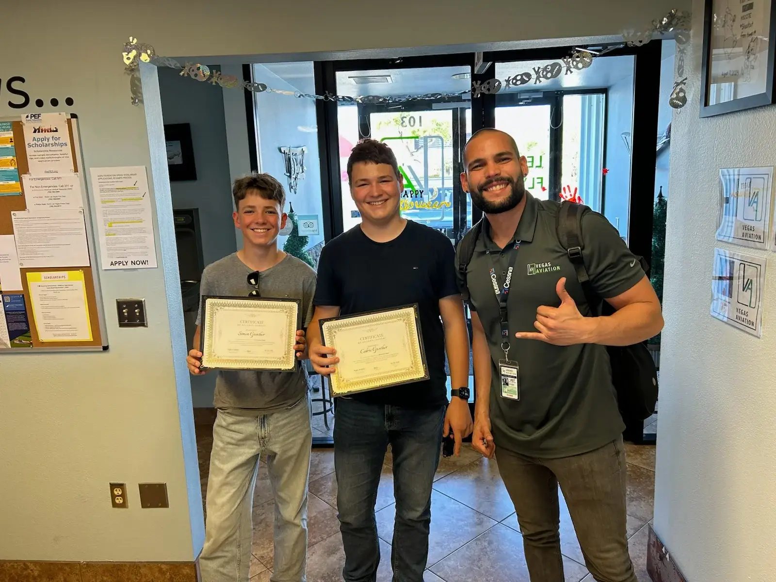Students holding Discovery Flight certificates at Vegas Aviation