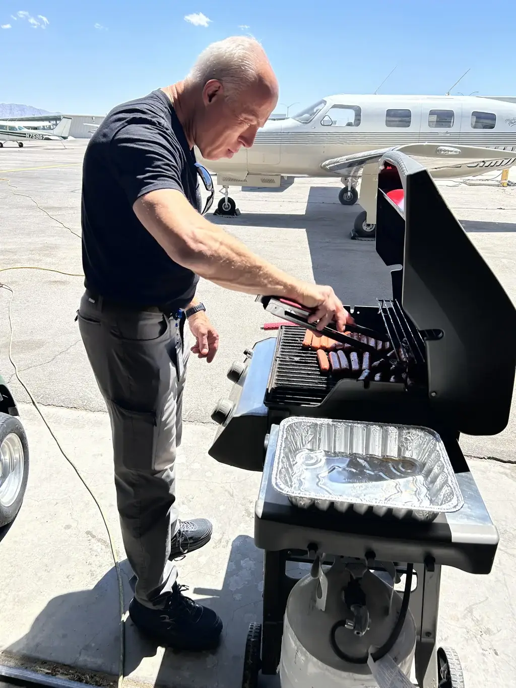 Vegas Aviation team grilling hot dogs during Frankfurter Friday