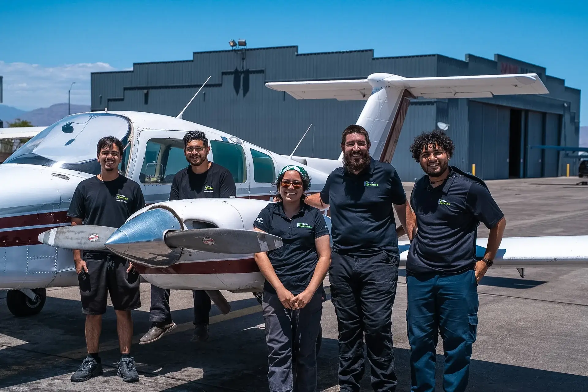 Vegas Aviation mechanics team in front of a Beechcraft Duchess multi-engine aircraft
