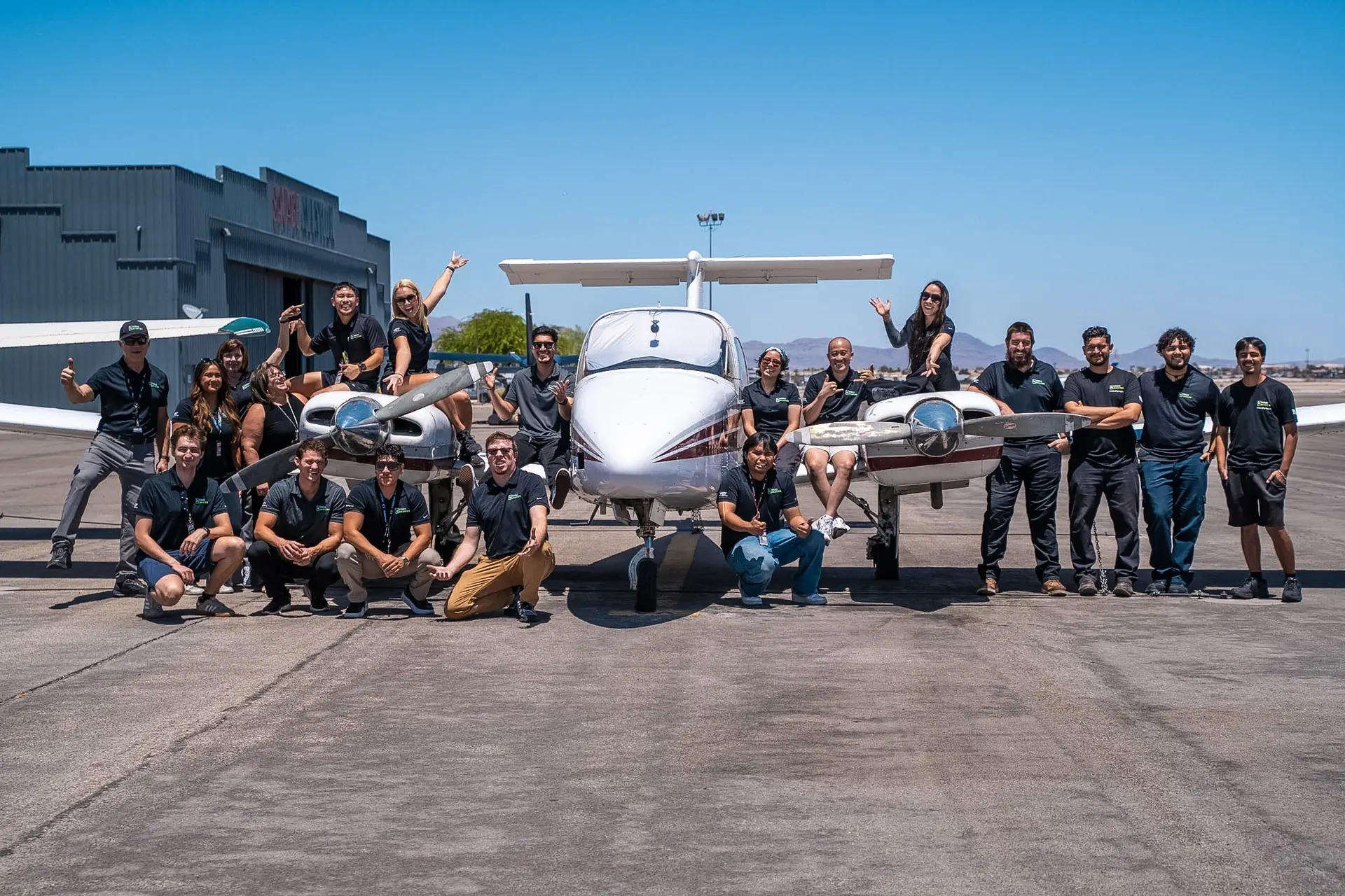 Vegas Aviation team in front of a Beechcraft Duchess multi-engine aircraft