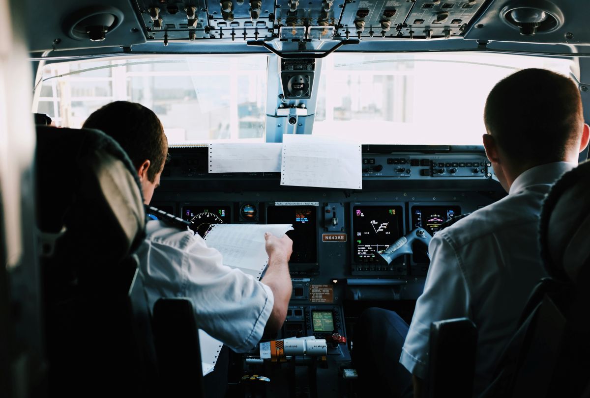 Cockpit view of pilot and co-pilot preparing flight instruments during private jet operation.”